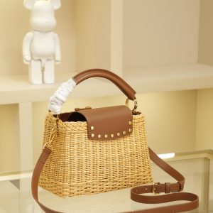 Alternative view of This Capucines BB handbag features a distinctive wicker-woven silhouette, paying homage to the Louis Vuitton picnic basket design introduced in 1892. The top handle and flap are crafted from calf leather, while the V-shaped lettering exudes a metallic finish. The removable and adjustable leather shoulder strap allows for versatile carrying options. Size: 27 * 17.3 * 9 cm